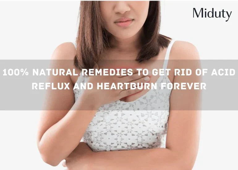 Person with long hair holding their chest, showing discomfort related to heartburn or acid reflux.