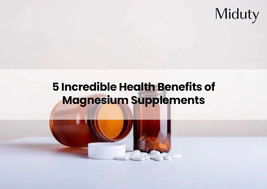Two brown bottles of magnesium supplements with white pills on a light background.