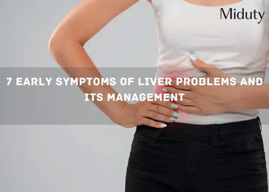 Person holding their abdomen, suggesting discomfort related to liver symptoms