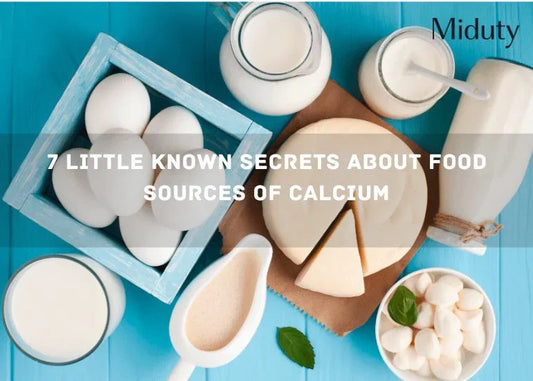 Variety of foods rich in calcium including eggs, milk, and cheese on a blue background