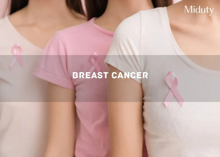Three women wearing pink shirts with pink ribbons for breast cancer awareness