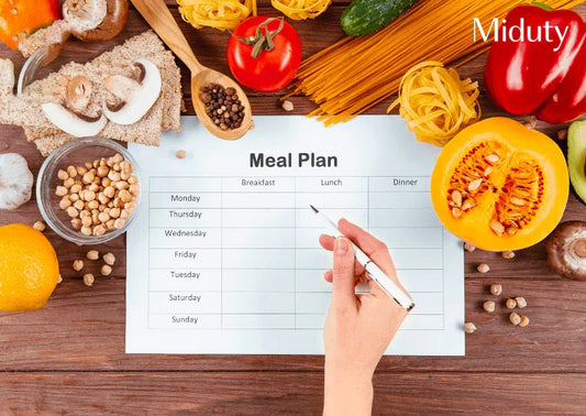 Meal planning with vegetables, pasta, and a blank template for a week.