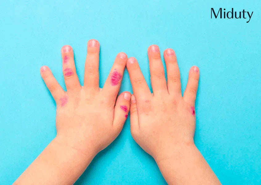 Two hands with visible markings on a blue background