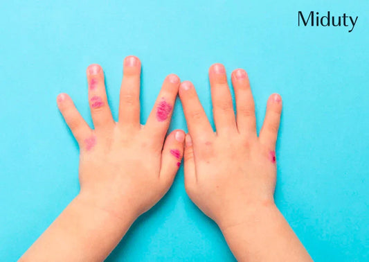 Two hands with visible markings on a blue background