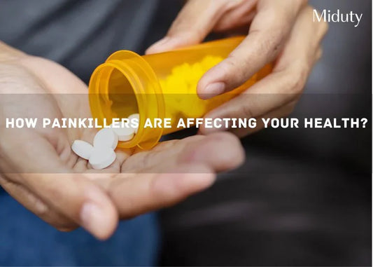 A person holding a prescription bottle with white pills spilling out.