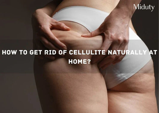 Person holding their thigh to show cellulite, wearing white underwear