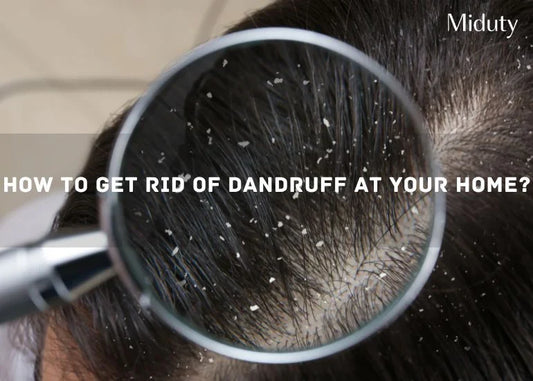 Close-up view of a scalp showing dandruff flakes under a magnifying glass.