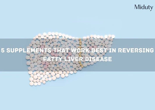 Pills arranged in the shape of a liver on a blue background