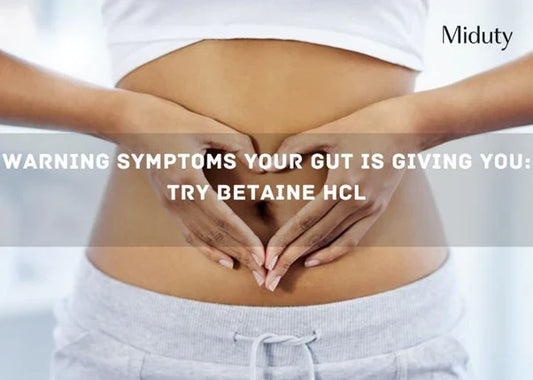 Person forming a heart shape with hands over their belly, emphasizing gut health awareness.