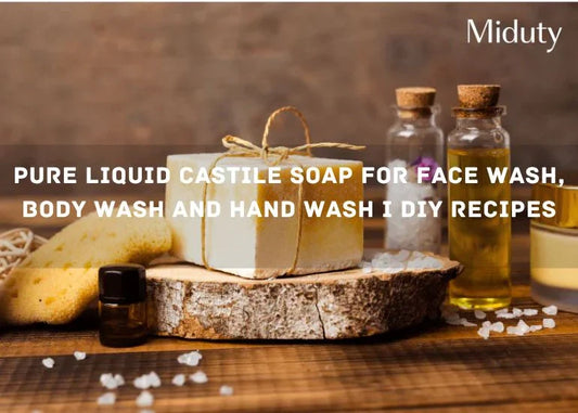 Bar of Castile soap on a wooden surface with essential oils and a sponge nearby