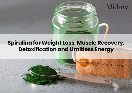 Green spirulina powder in a spoon beside a glass jar and tag labeled SpiruLina