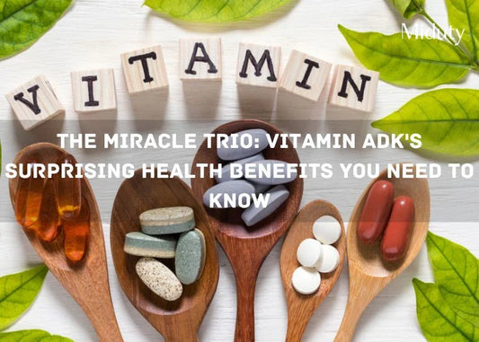 Various vitamin supplements arranged on wooden spoons with green leaves in the background