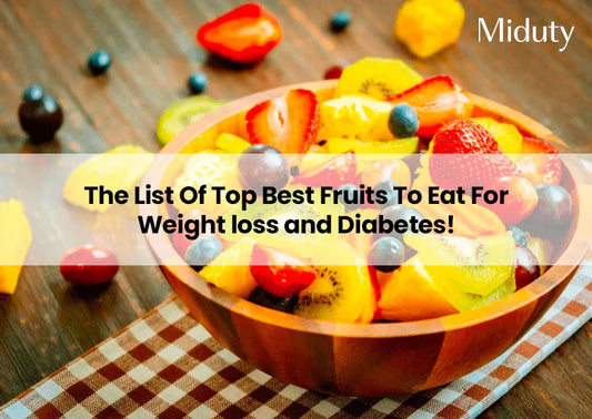 Bowl of colorful mixed fruits on a wooden table with a checkered cloth