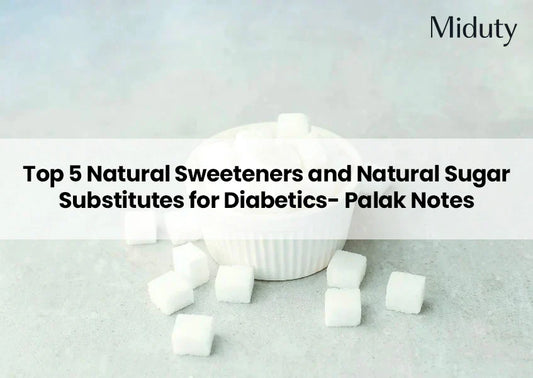 White sugar cubes next to a small white bowl on a gray surface.