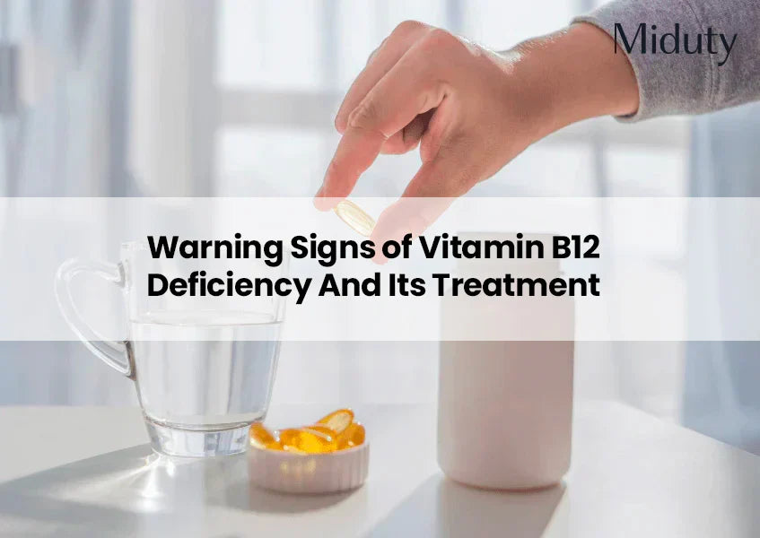 Hand holding a vitamin capsule over a glass of water and a container of supplements