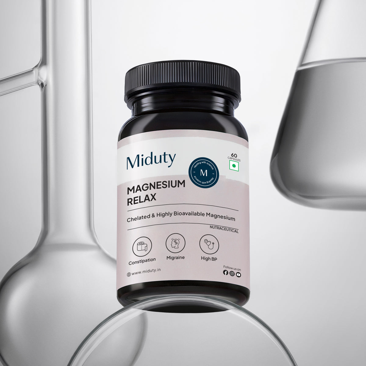 A bottle of Miduty Magnesium Relax supplement with a label that indicates it contains chelated highly bioavailable magnesium. The bottle is in front of a white background with a beaker and a test tube in the background, suggesting the product's use for relaxation and stress relief.